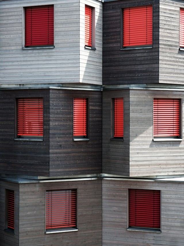 Modular facade with red window shutters